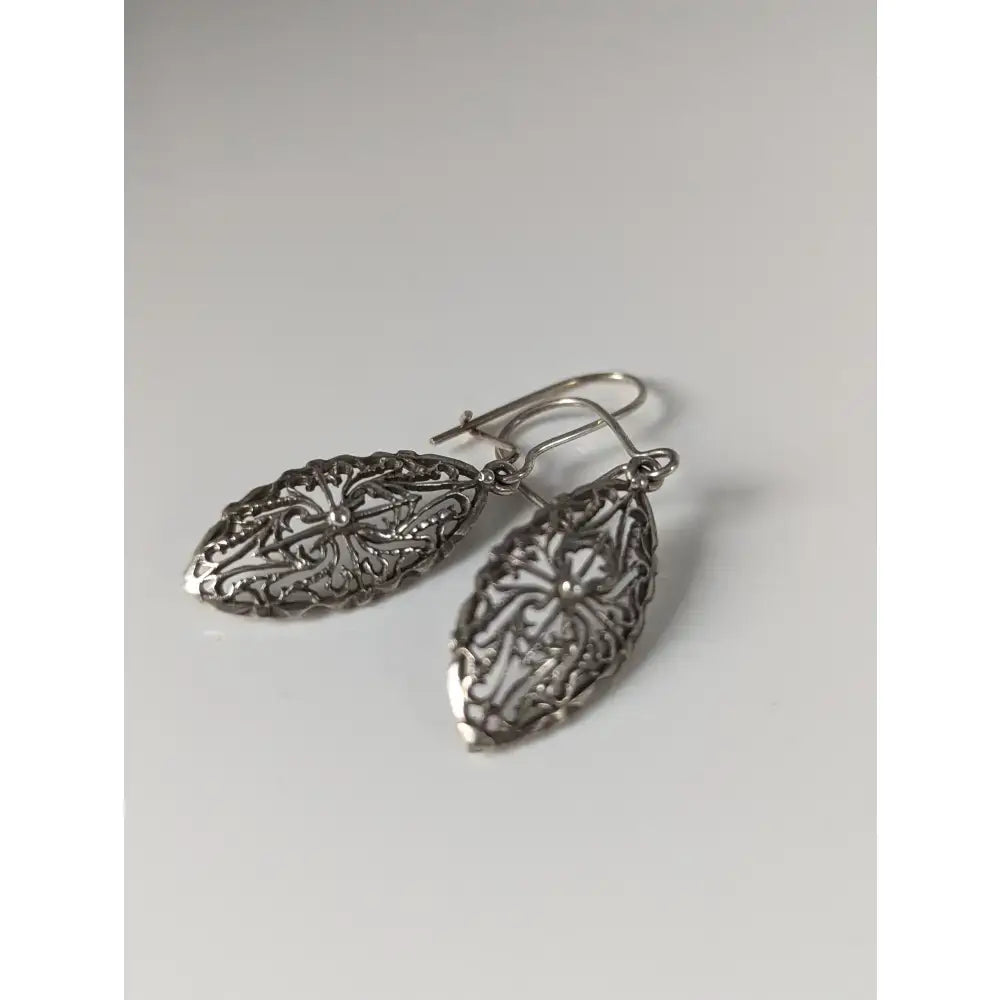Silver steed shield dropped earrings with intricate silver filigree floral patterns and polished metallic finish