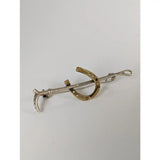 Silver and gold-toned horseshoe pin with curved design perfect as a silver steed shoe stock tie pin or cane gold brooch