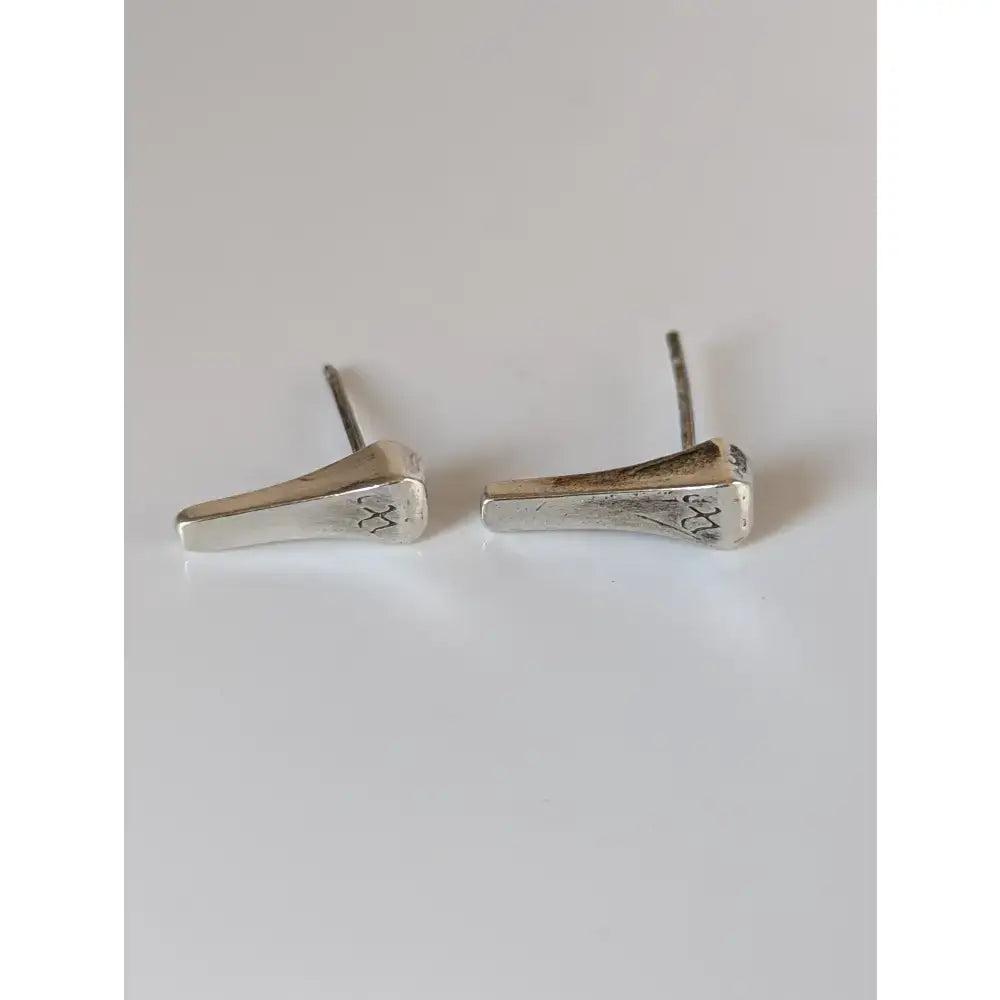 Silver steed short hoof nail stud earrings with silver textured finish and subtle engraved cross patterns