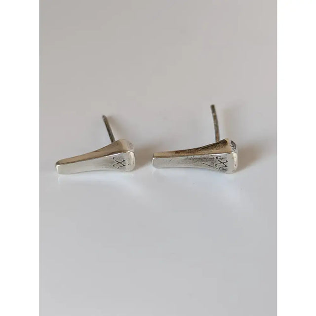 Silver steed short hoof nail stud earrings with silver textured finish and subtle engraved cross patterns