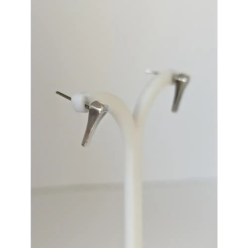 Silver steed short hoof nail stud earrings with silver-toned angular design and small white spherical accents