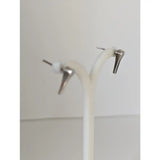 Silver steed short hoof nail stud earrings are silver-toned minimalist studs with pointed design and white accents