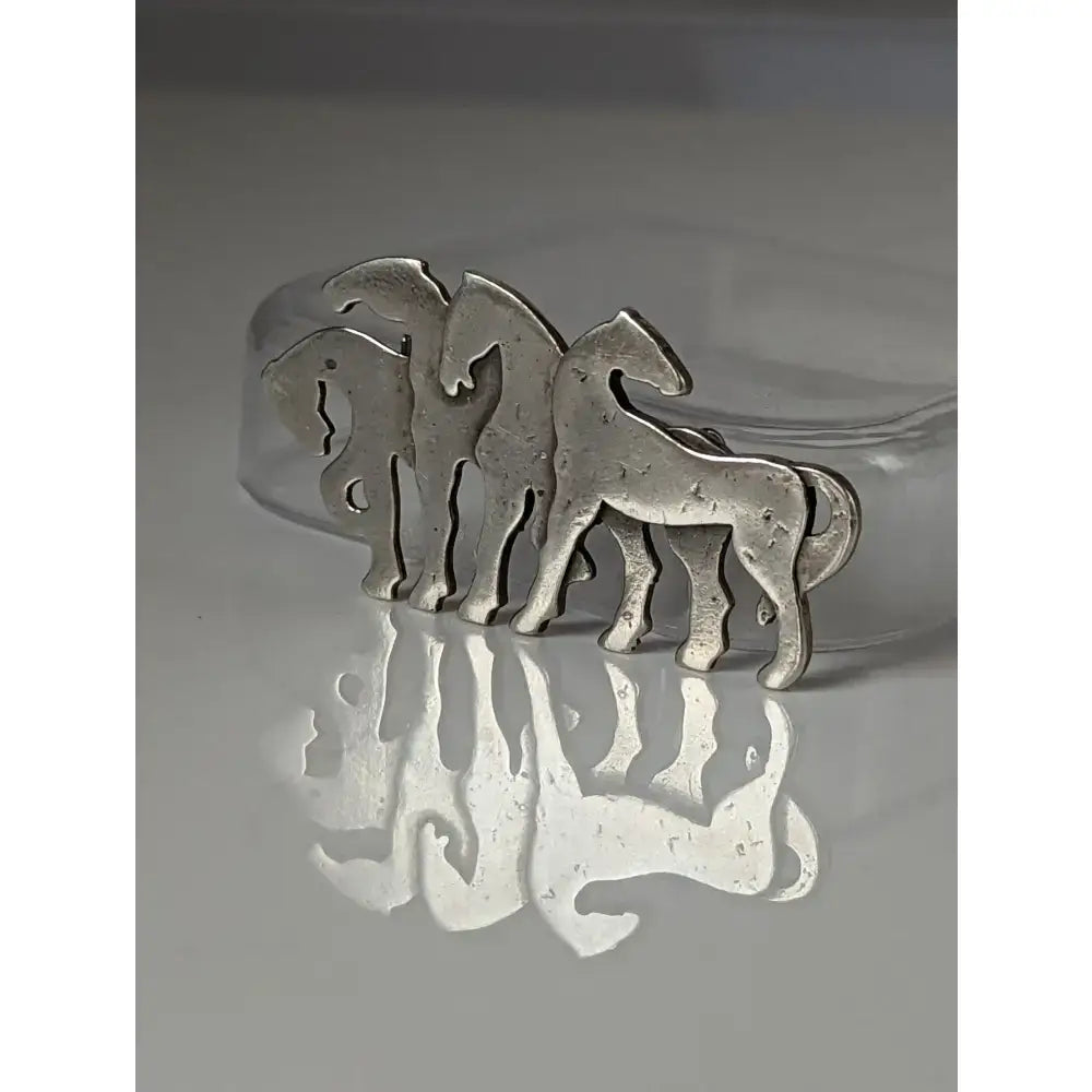Silver steed signature silver-toned metal stock tie pin with three stylized horse silhouettes herd silver brooch design