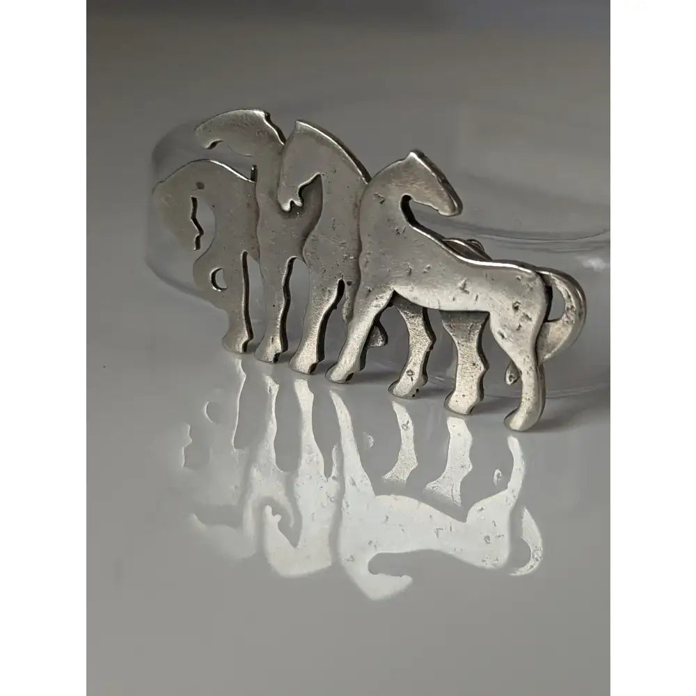 Silver steed signature silver-toned metal stock tie pin with three stylized horse figures in interlocking herd silver brooch design