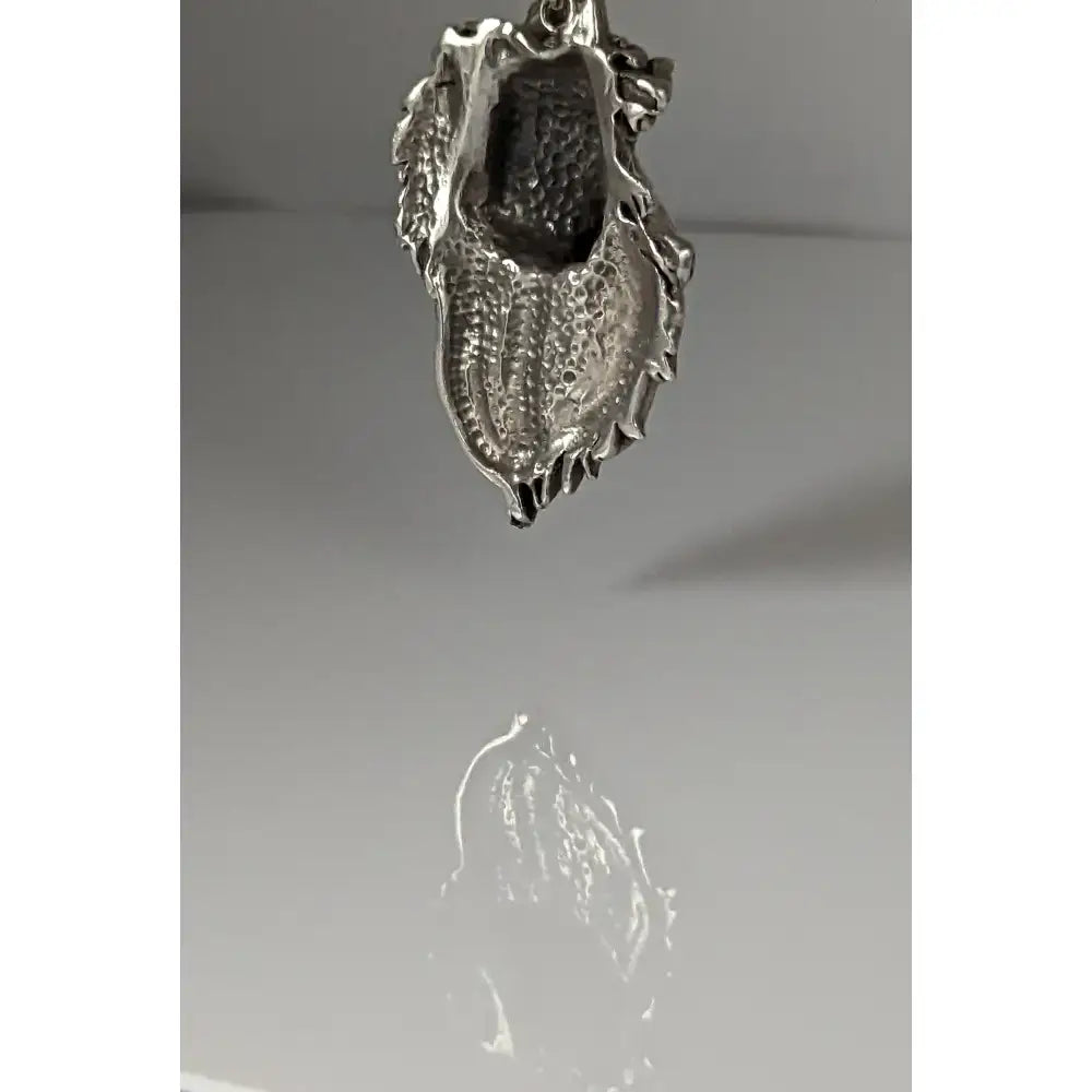Silver steed signature horse head pendant with textured hammered silver dragon design and intricate scales detail