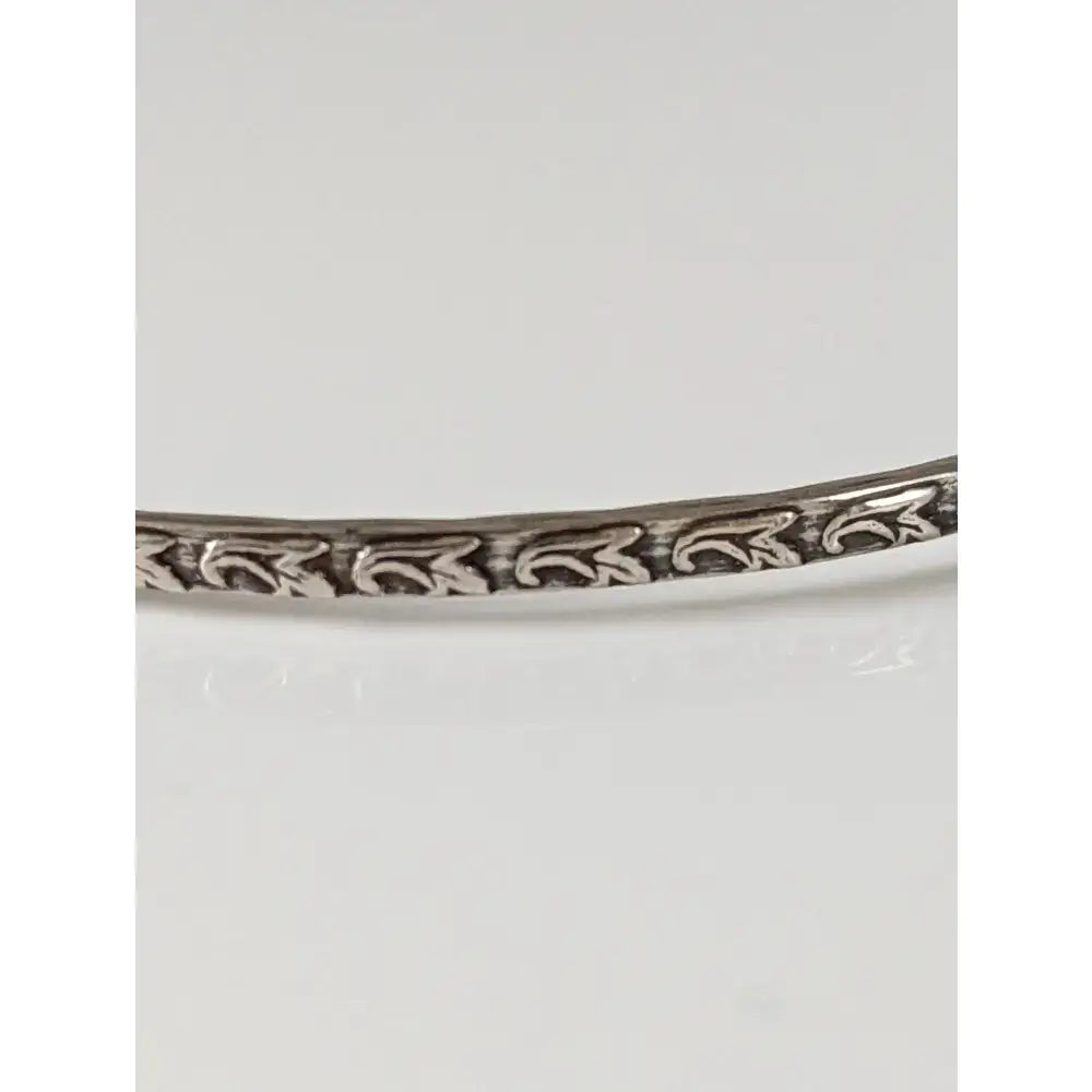 Silver Steed Slim silver bangle with intricate floral vine engraving in shiny silver perfect for everyday wear