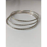Set of three silver steed slim vine silver bangles with intricate engraved patterns on silver-toned metal