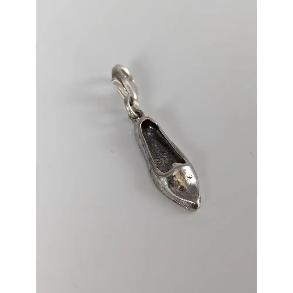 Silver steed slipper silver charm is a silver charm with intricate shoe details and a polished metallic finish with clasp