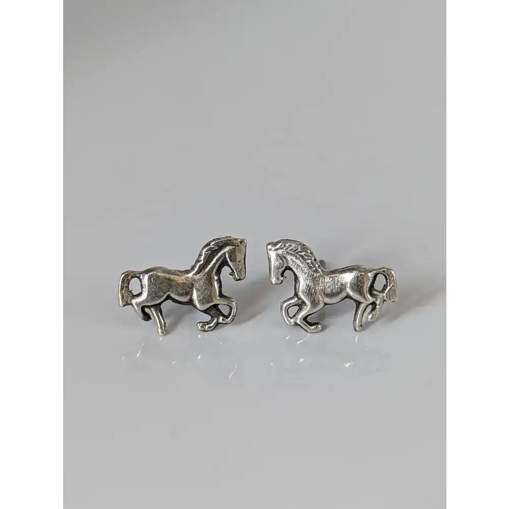 Small silver horse stud earrings in silver with detailed sculpted manes and tails perfect as horse stud earrings
