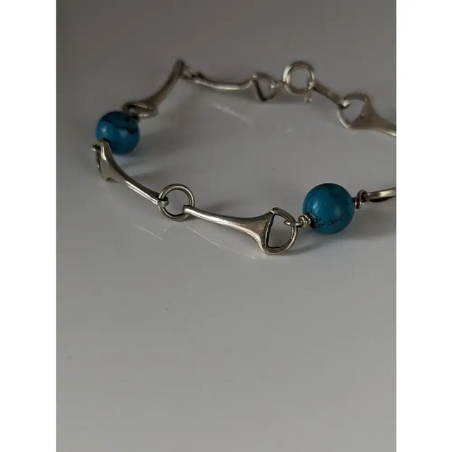 Silver steed snaffle solid silver bracelet with turquoise beads showcasing a stylish horsebit design