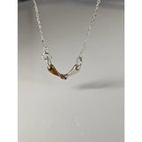 A delicate silver and gold-toned steed snaffle necklace with a fine chain called silver steed snaffle necklace