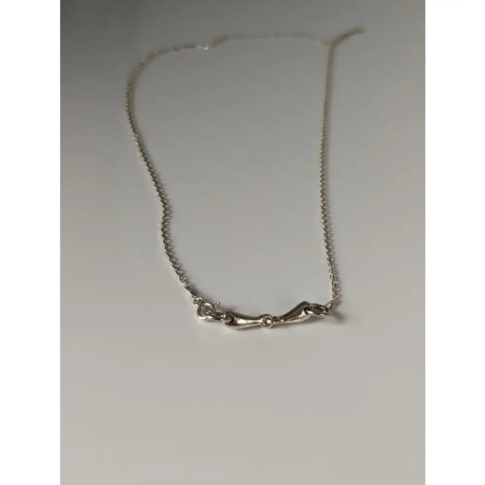 Silver steed snaffle necklace silver chain with delicate sculpted bone shaped pendant in silver steed style