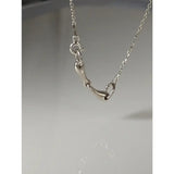 Silver steed snaffle necklace featuring a silver horsebit pendant with a delicate chain and polished metal finish