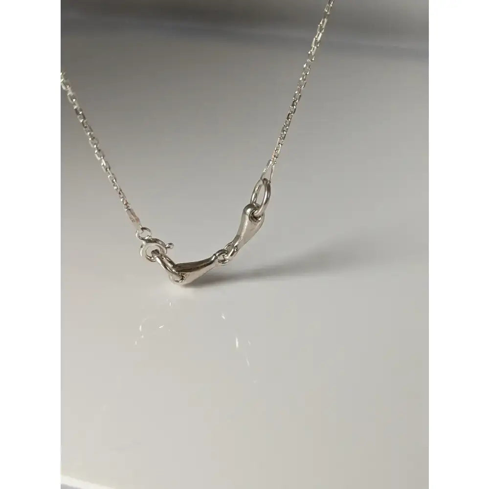 Silver steed snaffle necklace featuring a minimalist silver horsebit pendant on a sleek fine chain