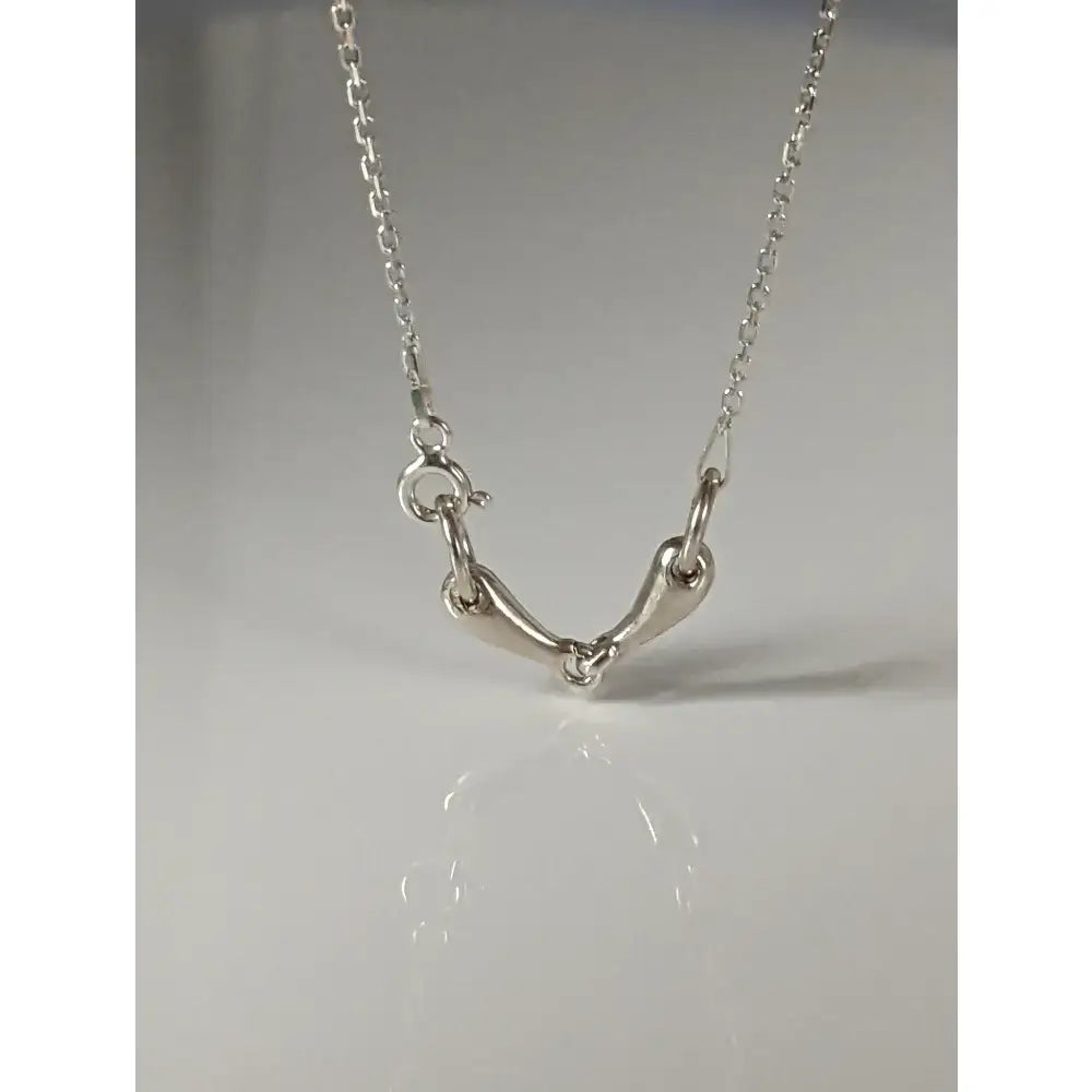 Silver steed snaffle necklace with sleek silver horsebit design and polished minimalist metal finish