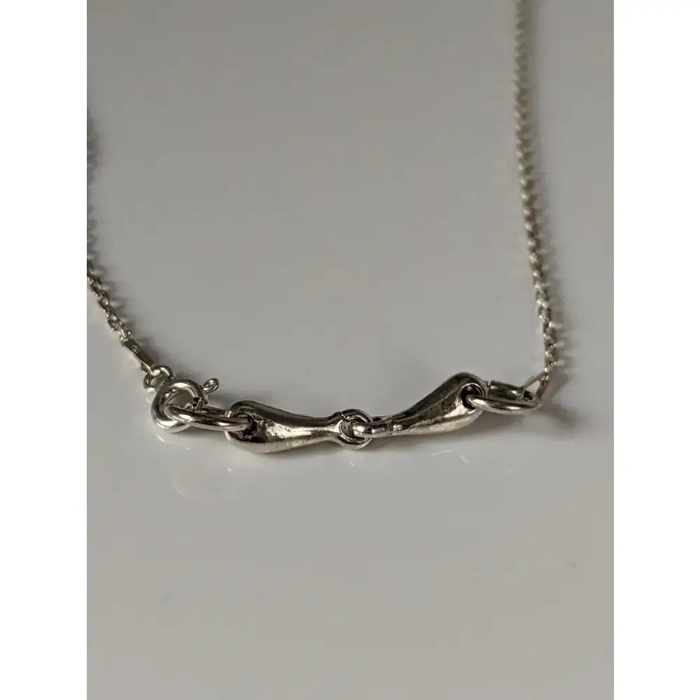 Silver steed snaffle necklace with silver horsebit style and textured elongated pendant on a fine chain