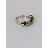 Silver steed snaffle ring with silver band featuring a silver and gold-toned horsebit and polished sleek design