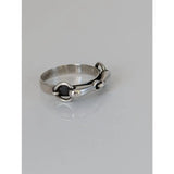 Silver steed snaffle silver horsebit ring with black inlay and polished silver metal finish on a smooth band