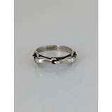 Silver steed snaffle silver horsebit-style ring with polished metallic finish and intricate interlocking design on silver band