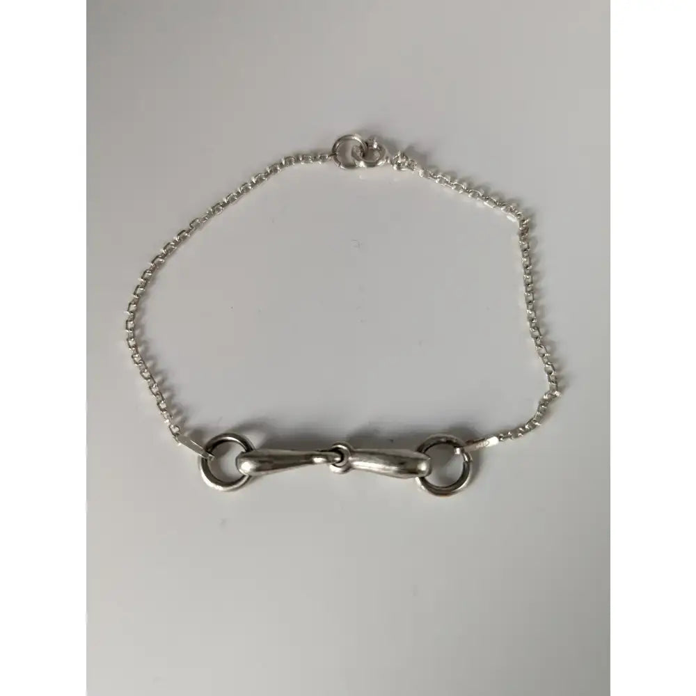 Silver steed snaffle chain delicate bracelet with silver horsebit and polished metallic linked chain design