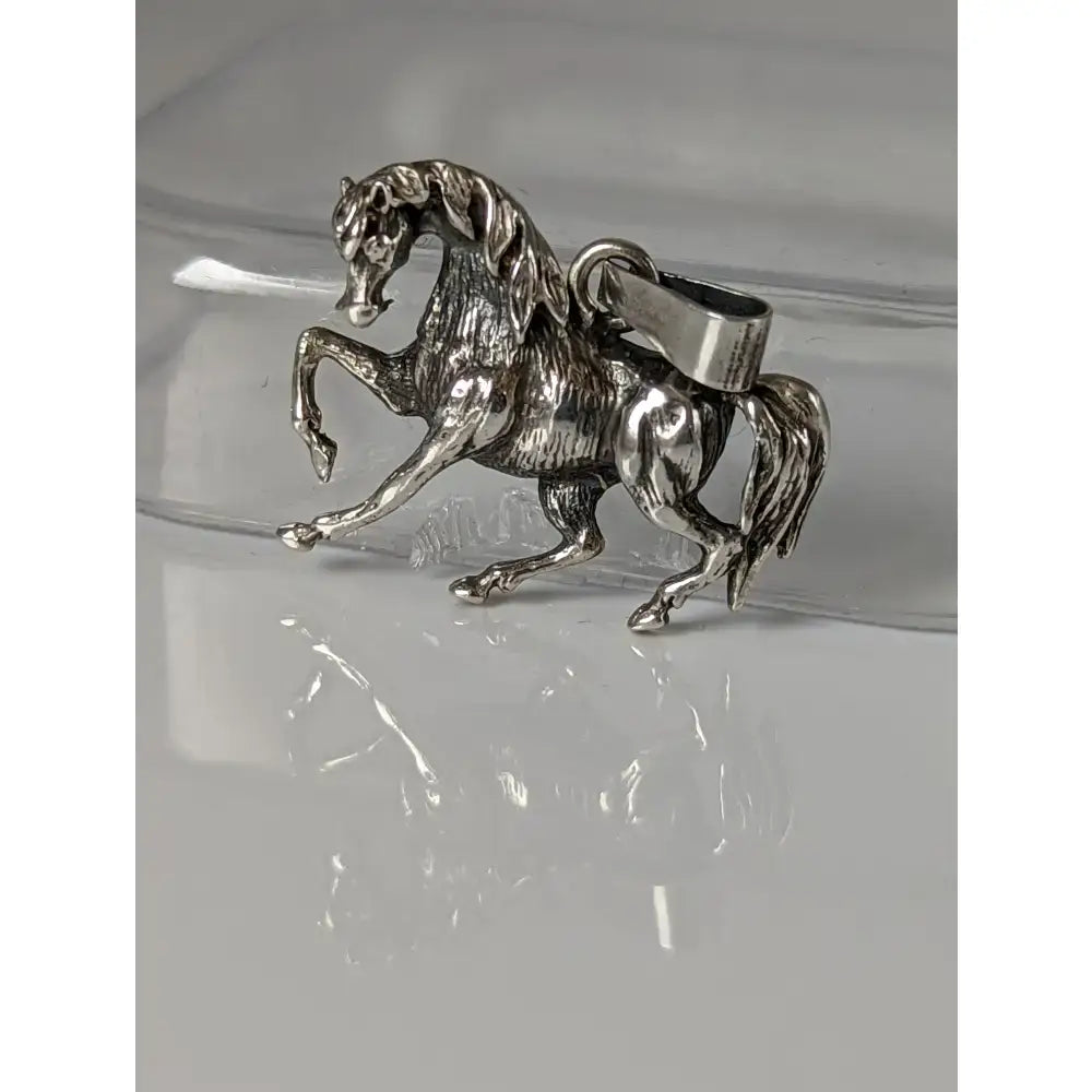 Silver steed stallion silver pendant with detailed sculpted mane and tail and sturdy metal clasp for easy attachment