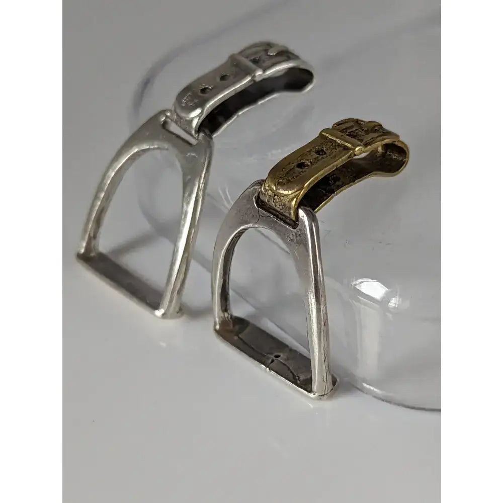 Silver steed stirrup silver pendant featuring silver and gold-toned horse stirrups with ornate buckle designs