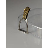 Silver steed stirrup silver pendant featuring a silver stirrup with gold-toned leather strap and buckle