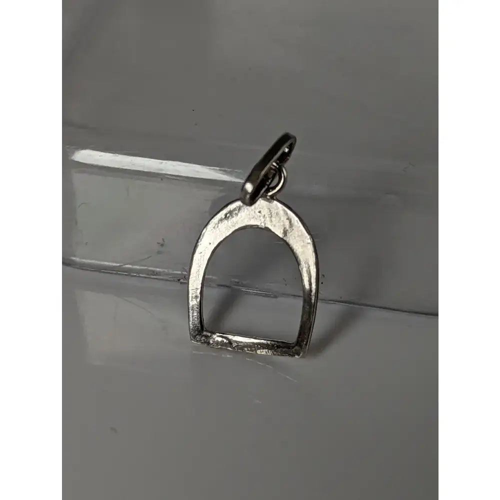 Silver steed stirrup pendant in polished silver with textured finish and loop for equestrian jewelry attachment