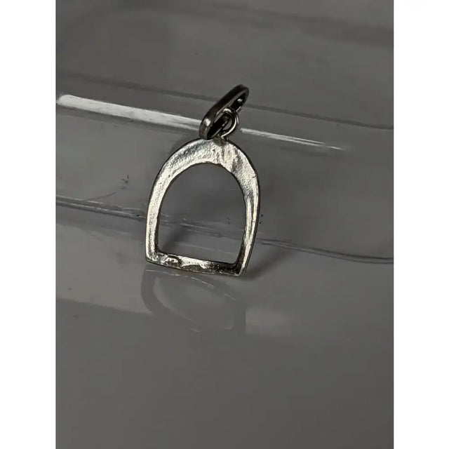 Silver steed stirrup pendant in silver with a textured surface and loop perfect for equestrian jewelry fans