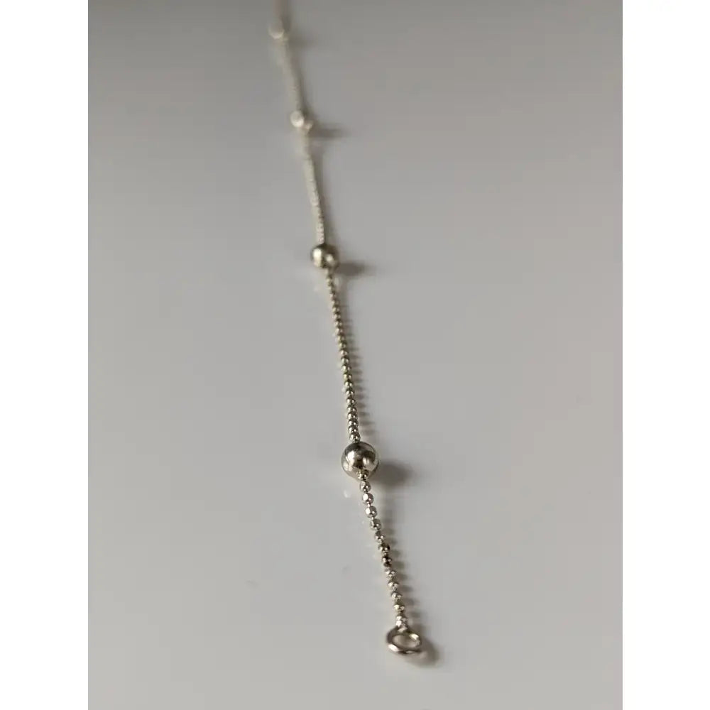 Silver steed studded chain silver bracelet featuring a silver studded ball chain with spherical accents and a small ring end