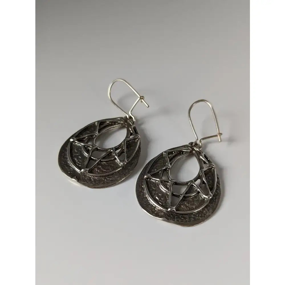 Silver steed sunlight dropped earrings are handmade silver dangle earrings with geometric openwork and circular motifs