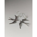 Silver steed swallow silver dropped earrings featuring detailed wing and body textures in sterling silver