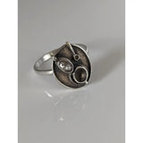 Silver steed tea silver ring with abstract textured face featuring a central oval element and small circular details