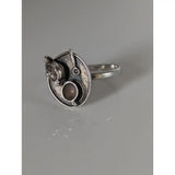 Silver steed tea silver-toned ring with circular textured face and miniature kitchenware sculptures showcasing silver craftsmanship
