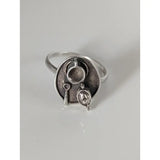 Silver steed tea ring with silver craftsmanship features a circular abstract face with three interconnected cups and dangles