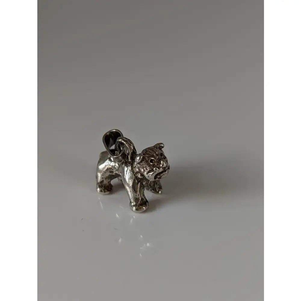 Silver steed terrier silver pendant features a detailed silver pendant charm shaped like a textured bulldog with a loop for hanging