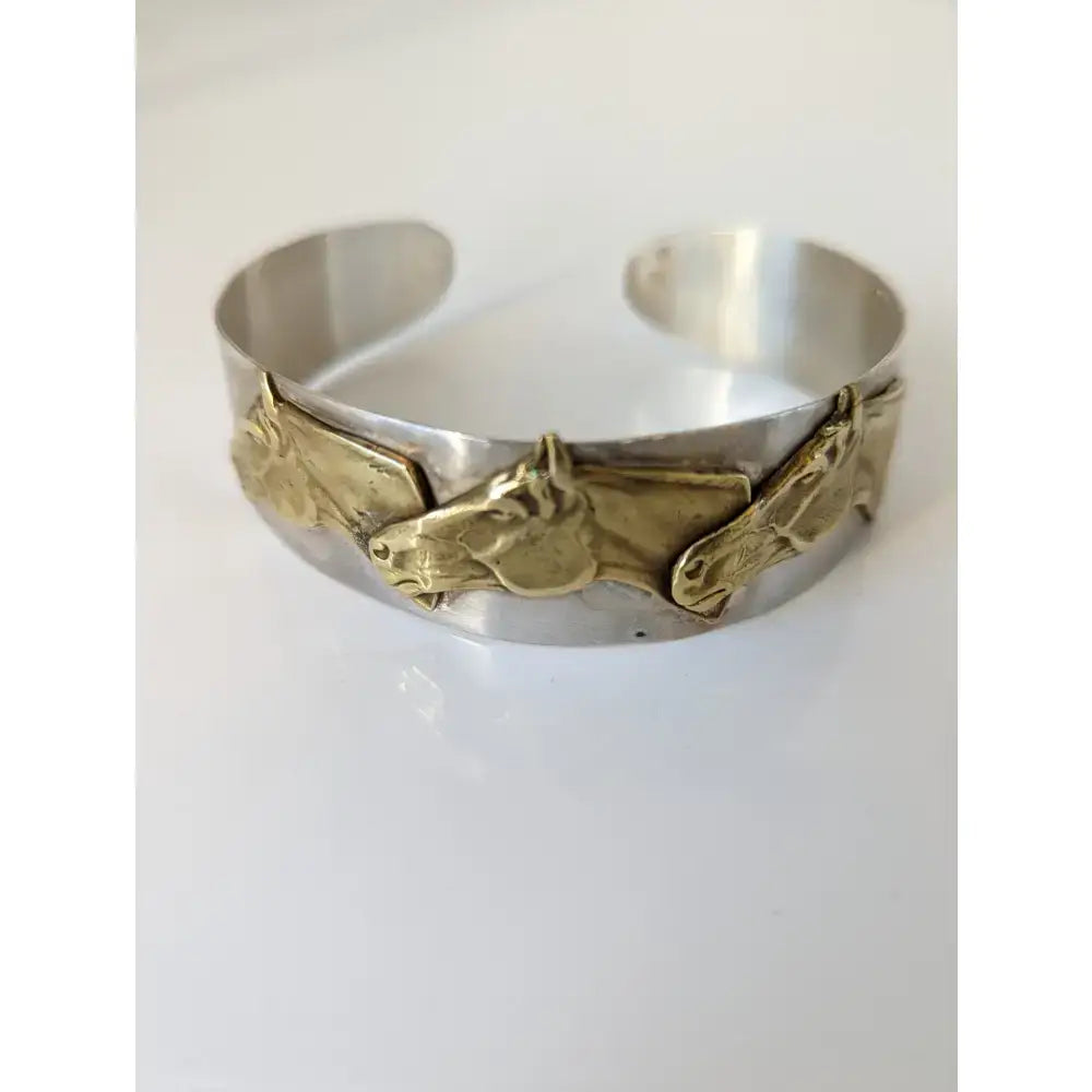 Silver steed three silver cuff bracelet with three horses heads bangle featuring raised golden horse head motifs