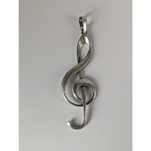 Silver steed treble clef silver pendant with a sleek polished metallic finish and elegant flowing design
