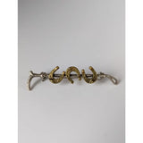 A silver steed triple cane brooch with a sleek silver hairpin and three gold accent horseshoe charms with intricate detail