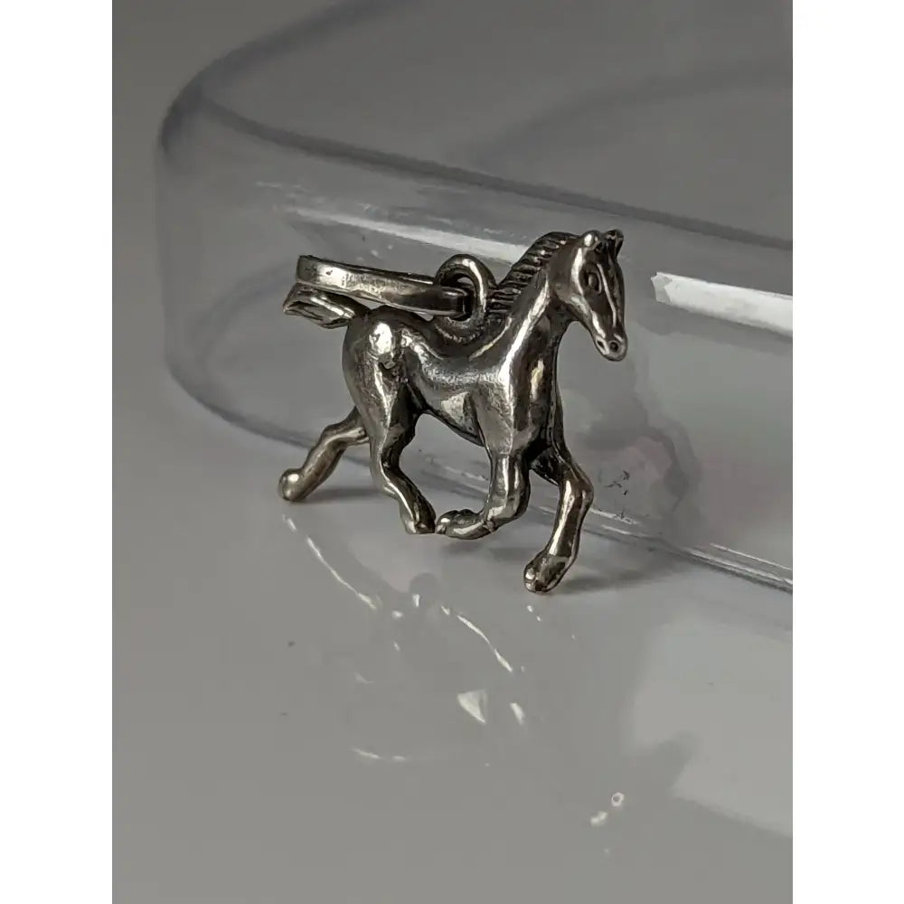 Silver steed trotting horse silver pendant with detailed mane and tail in polished silver and attachment loop