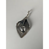 Silver steed tulip pendant featuring a polished silver calla lily petal with a detailed central seed pod