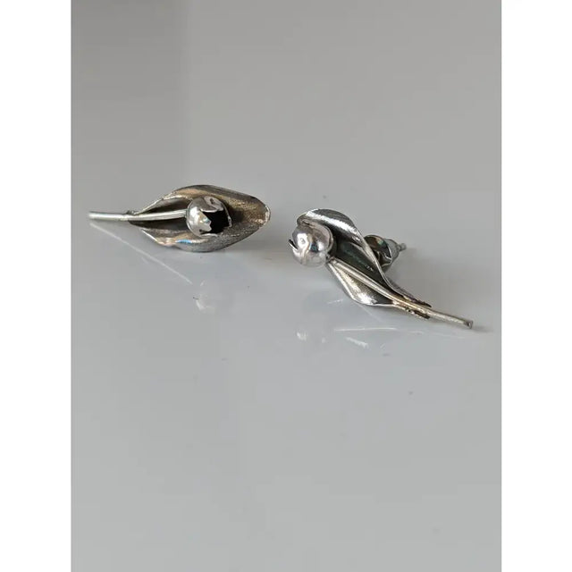Silver steed tulip stud earrings with silver leaf shape, polished finish, subtle texture, and central spherical accent