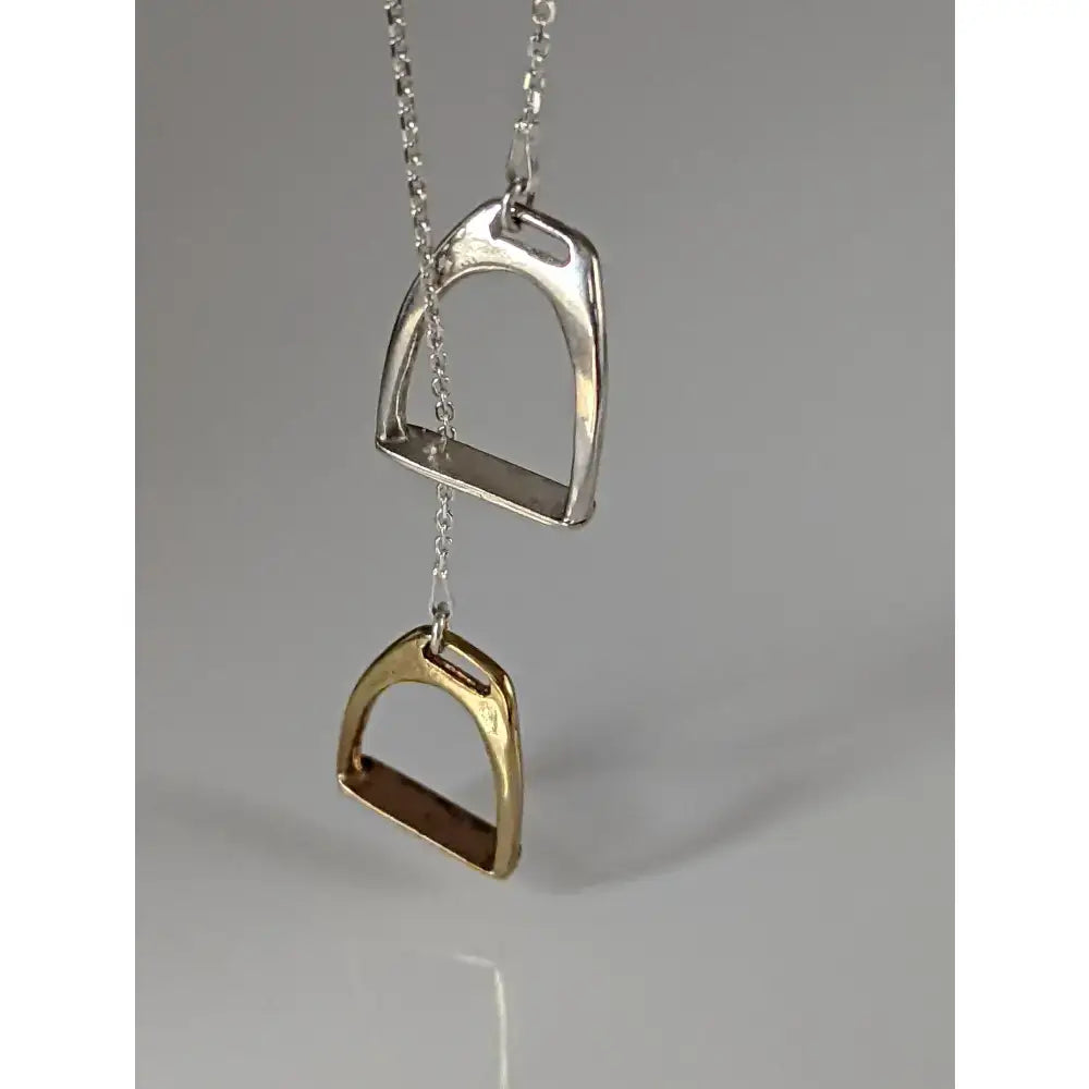 Silver steed two stirrups necklace featuring a silver and gold horse stirrup pendant with chain stirrups necklace