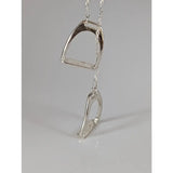 Silver steed equestrian jewelry featuring a silver two stirrups necklace pendant with a textured metallic finish