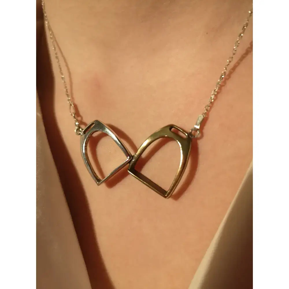 Silver steed equestrian jewelry featuring a silver two stirrups necklace with interlocking metal stirrup charms