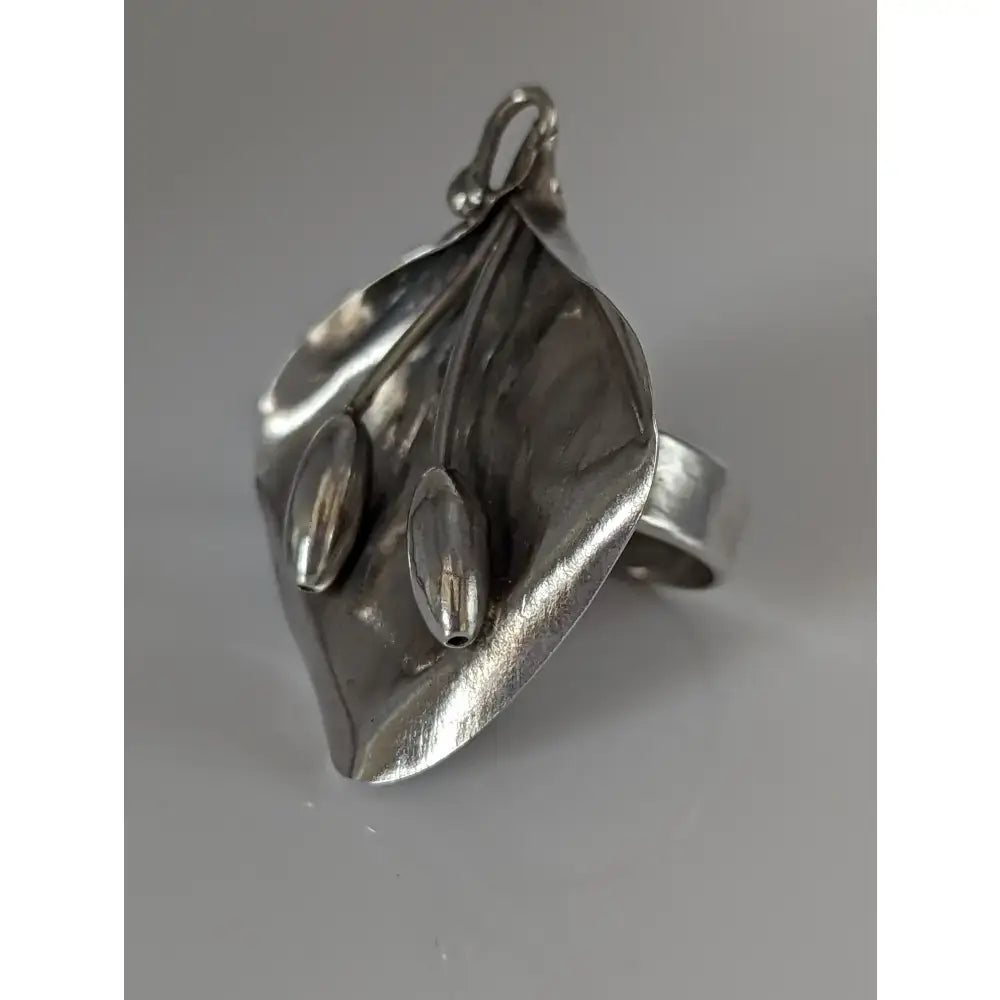 Silver steed unique silver ring shaped like a calla lily with elongated seed pods in an extravagant leaf design