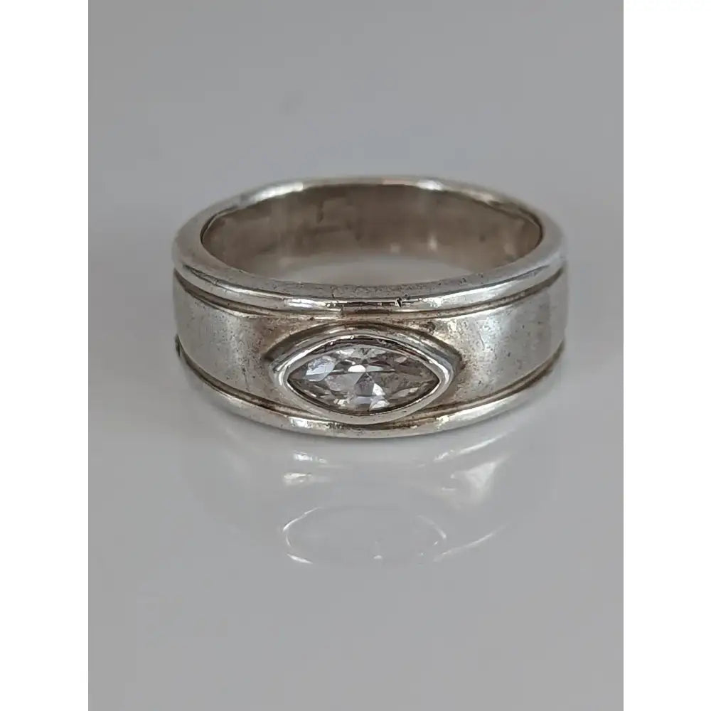 Silver steed zirconia band with marquise-cut clear stone in oval bezel and silver grooves on band sides