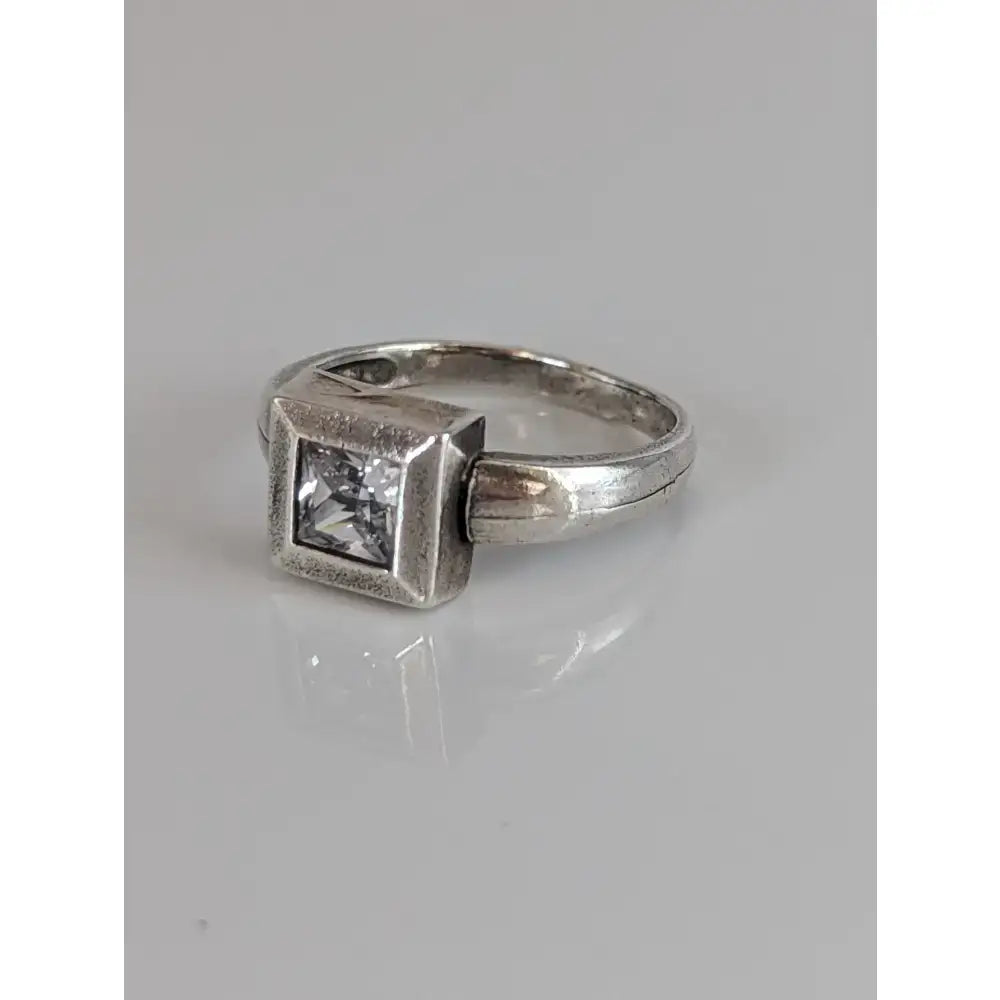 Silver steed zirconia square ring with a clear square-cut gemstone set in a textured geometric silver band