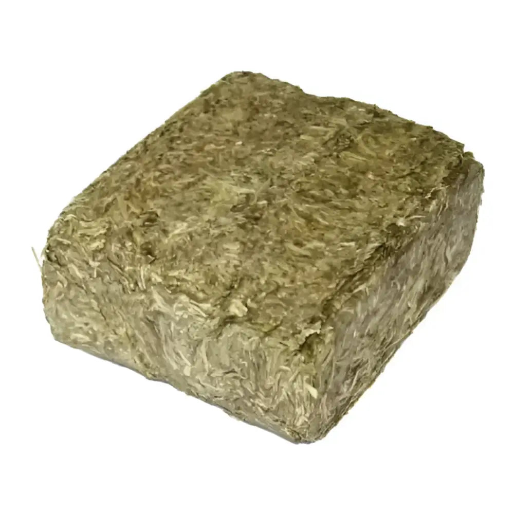 A dense rectangular block of compressed green and brown mature timothy grass in simple system horse feeds meadowbrix