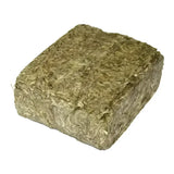 A dense rectangular block of compressed green and brown mature timothy grass in simple system horse feeds meadowbrix